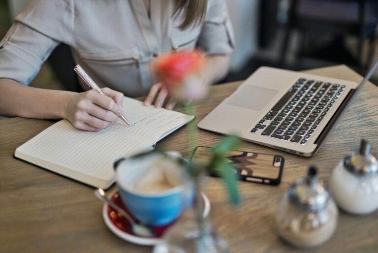 person writing in notebook